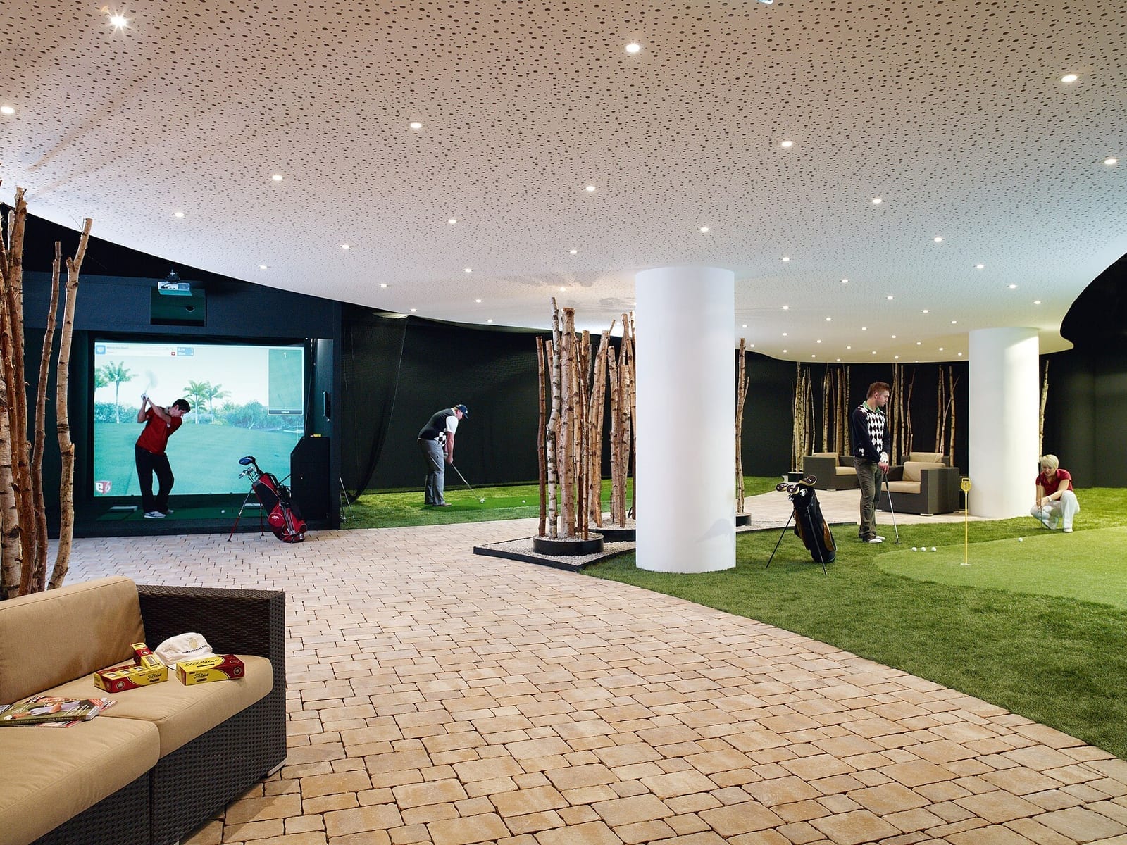 Indoor golf hitting bay and screen at a premium hotel golf facility