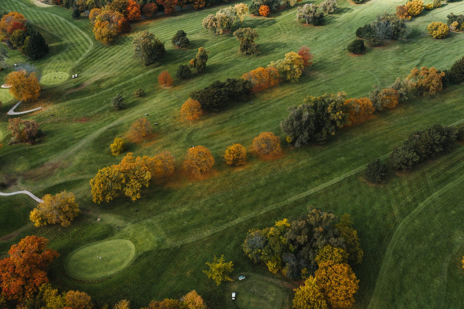 Aerial drone view of a golf course fairway in autumn