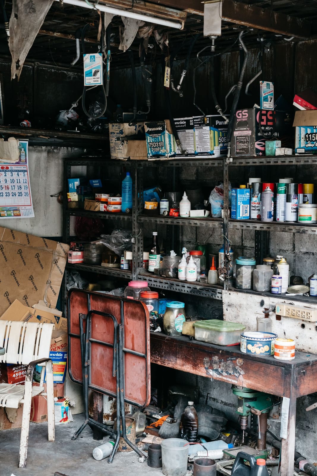 A garage interior with tools and shelving on the walls