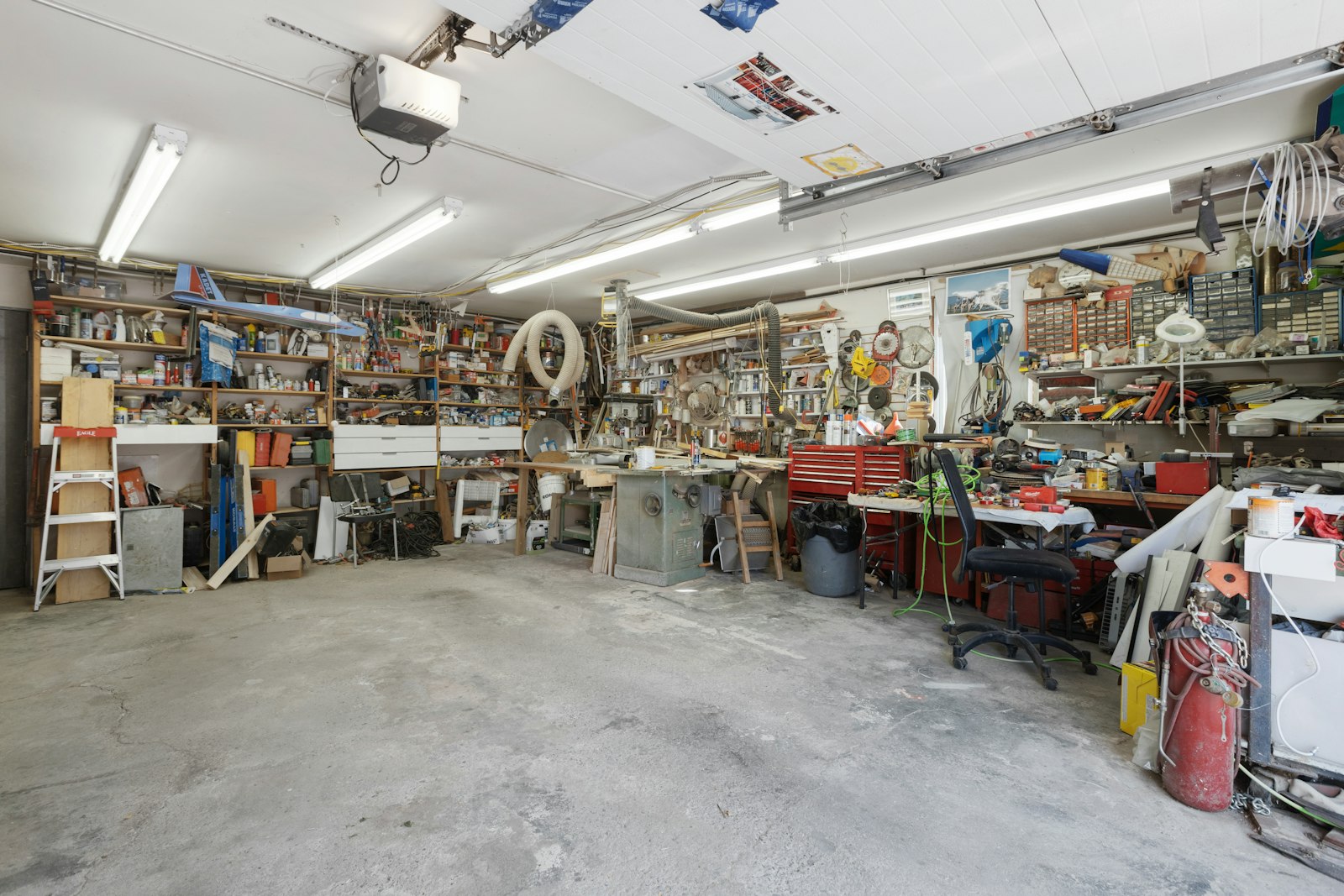 A garage mid-project with hand tools and equipment laid out