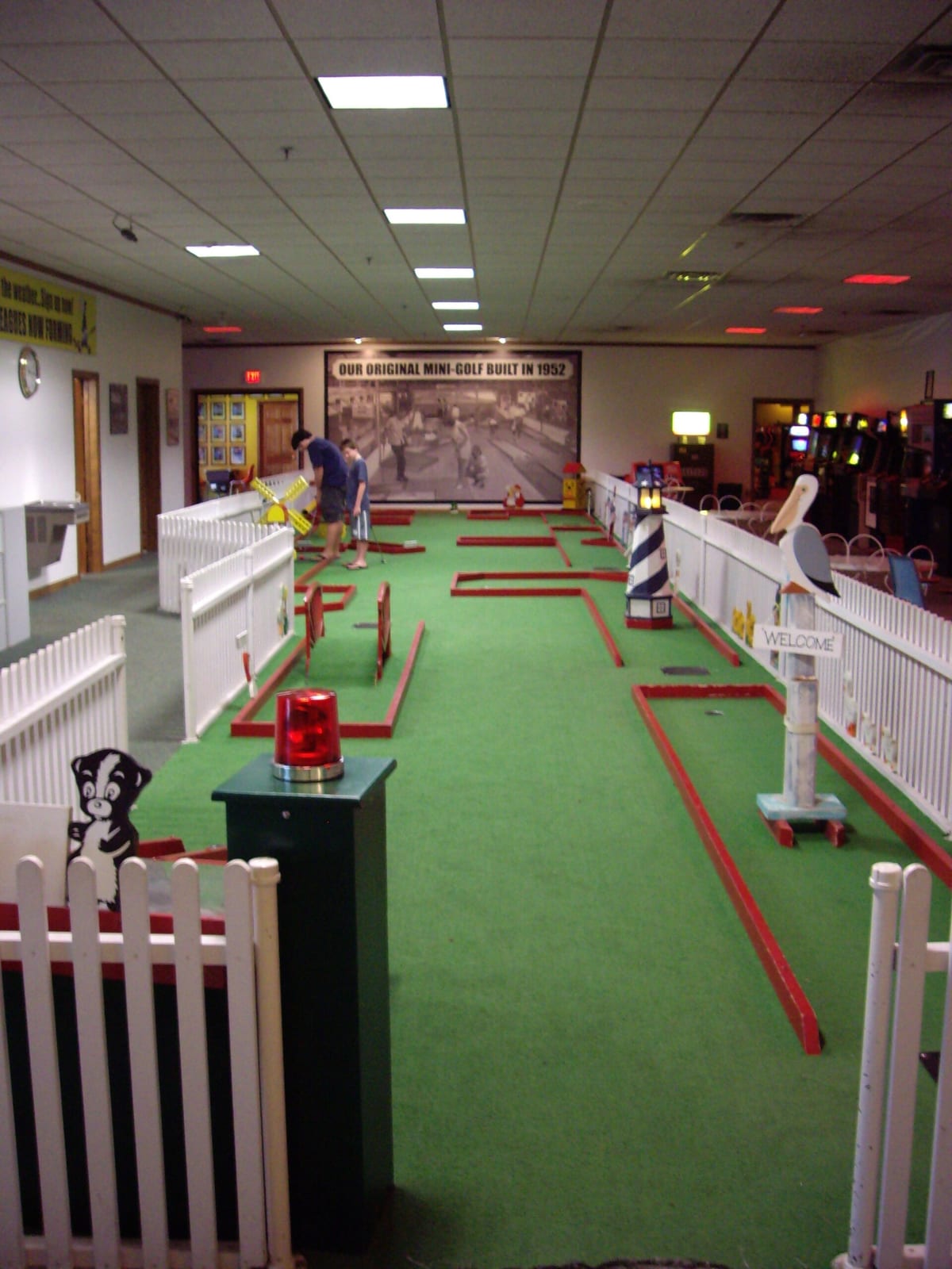 A home golf simulator bay with a large impact screen as the hitting surface