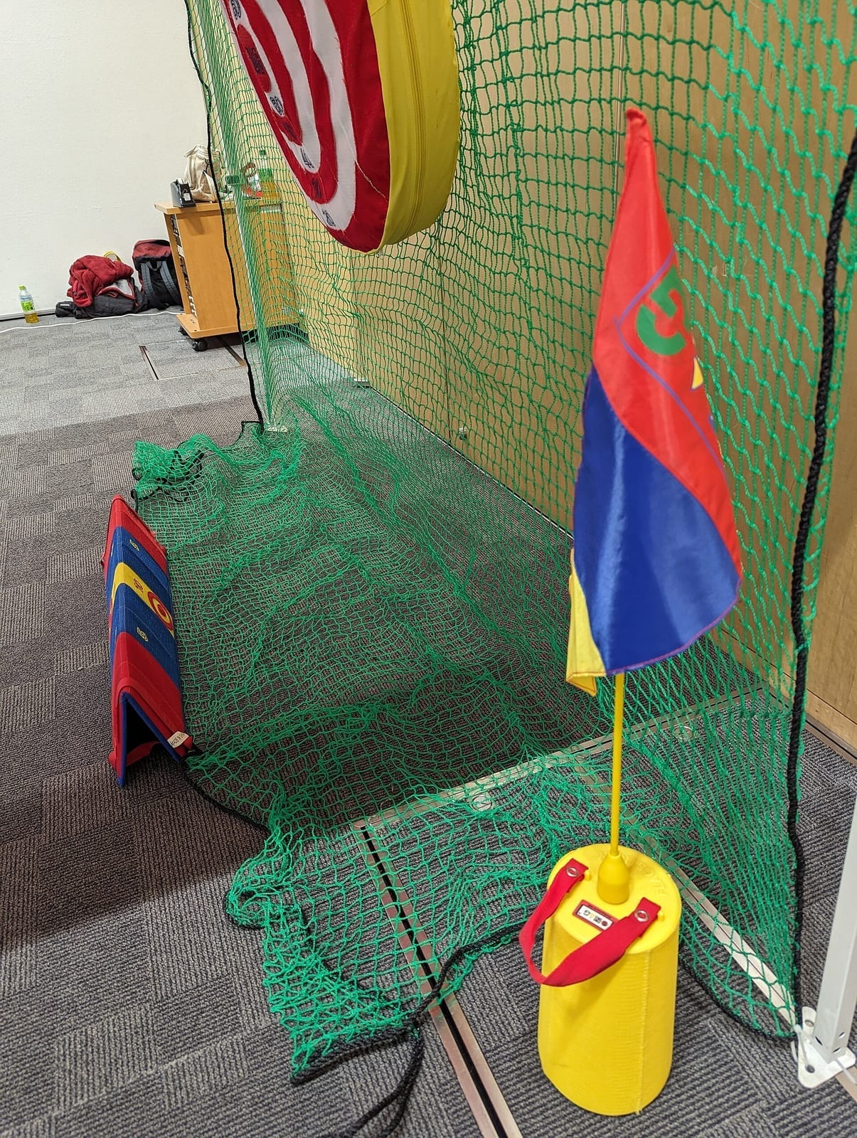 A compact indoor golf simulator practice facility